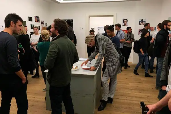 Audience viewing landscape photography works by Federico Antonello during exhibition in Berlin