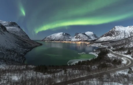 Northern lights above a fjord in the Lofoten Islands during winter, featured in a landscape photography tour in Norway