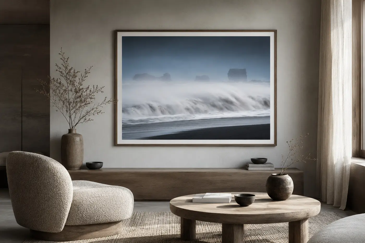 Black and white fine art photograph of the black sand coast near Vík, Iceland, with dramatic sea stacks and moody Atlantic atmosphere.
