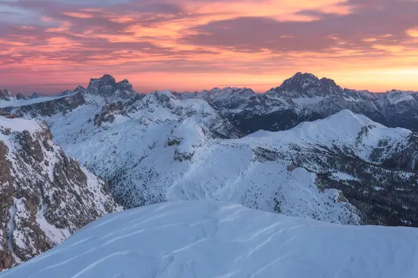 Snow-covered peaks seen from Lagazuoi at sunrise in the Dolomites near Passo Falzarego, Italy